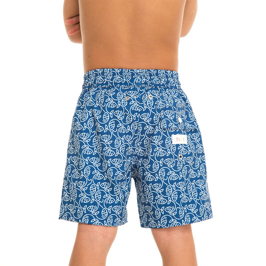 Blue swim shorts with white leaf pattern worn by a person on a white background