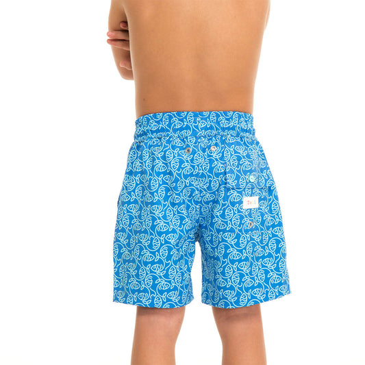 Blue swim shorts with white leaf pattern worn by a person on a white background