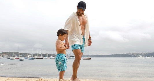 Father and son wearing colourful matching swimwear by Tolu Australia