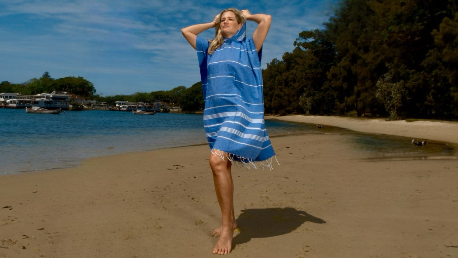 adult wearing hooded beach towel poncho after ocean swim Australia