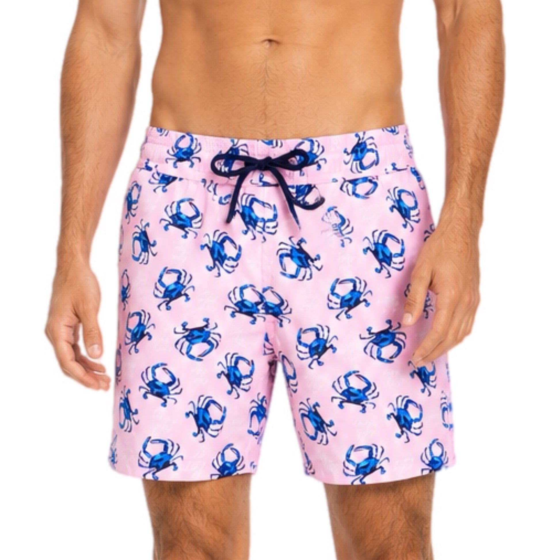 Pink swim shorts with blue crab pattern worn by a person on a white background