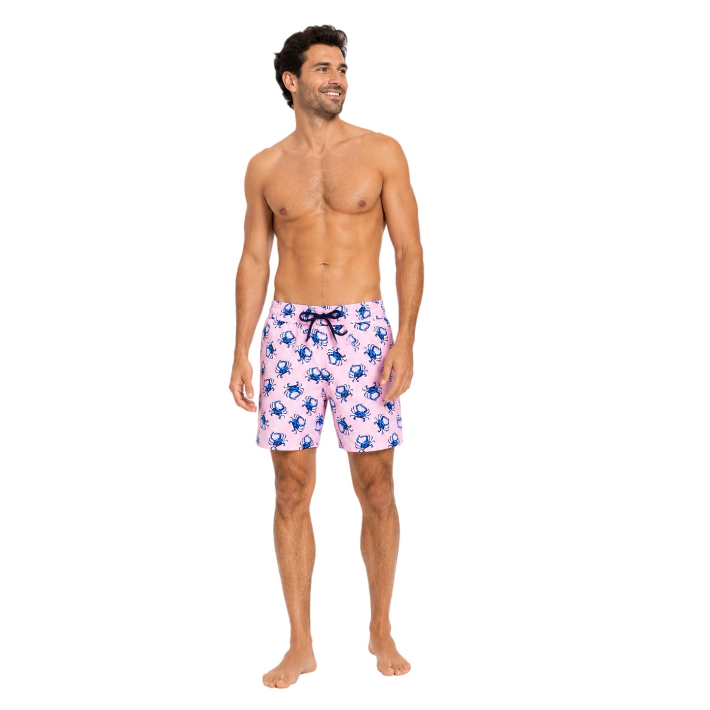 Man wearing pink swim shorts with blue crab pattern on a white background