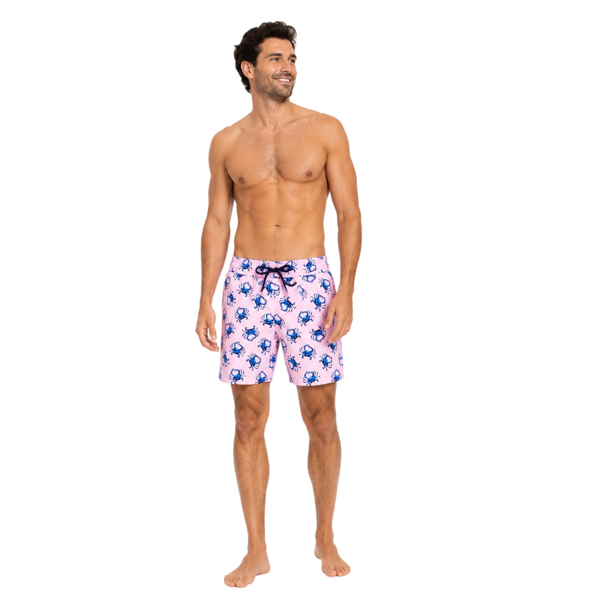 Man wearing pink swim shorts with blue crab pattern on a white background